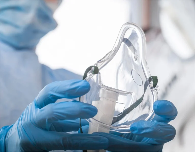 Oxygen mask being used by a health professional